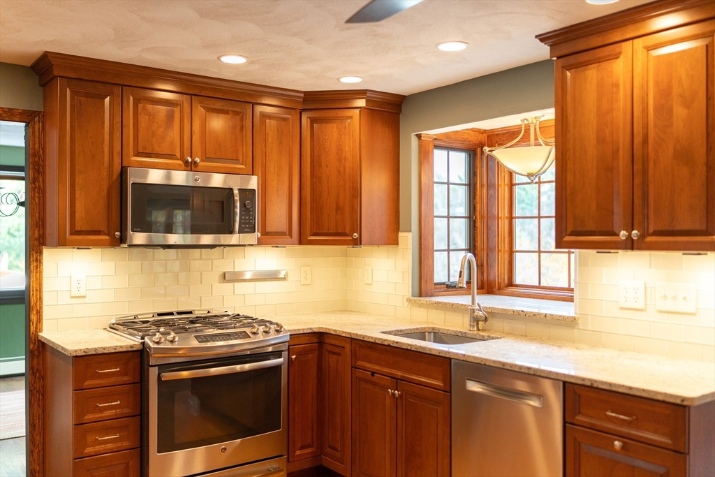 375 Winter Street Walpole, MA 02081 - Photo 16 of 40 a kitchen with stainless steel appliances a stove sink and microwave