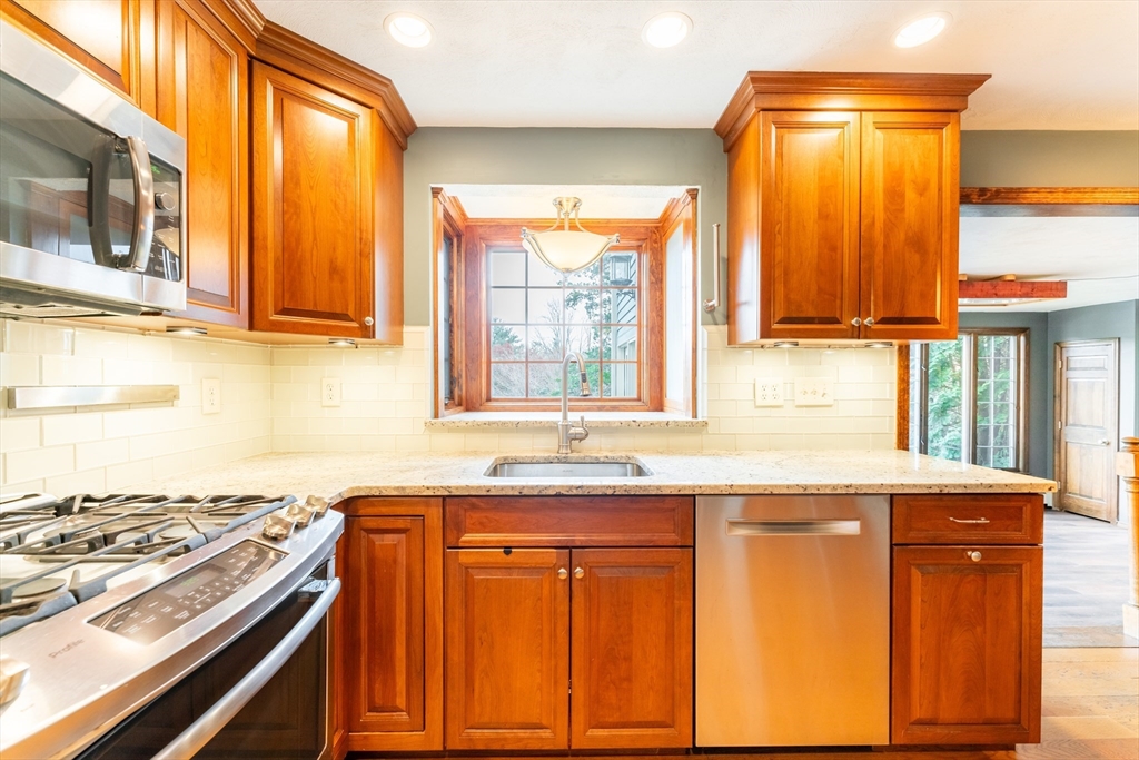 375 Winter Street Walpole, MA 02081 - Photo 17 of 40 a kitchen with stainless steel appliances granite countertop a sink and a stove