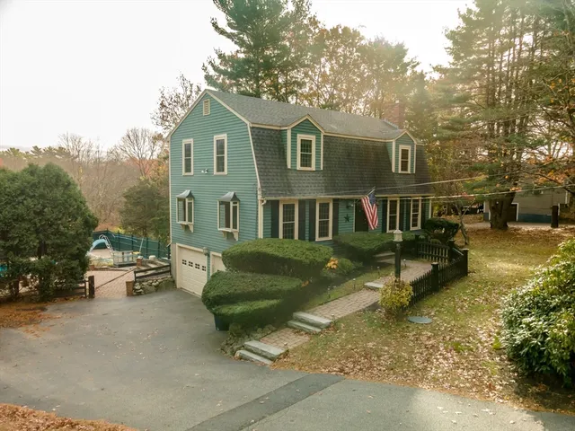 a view of a house with backyard and sitting area