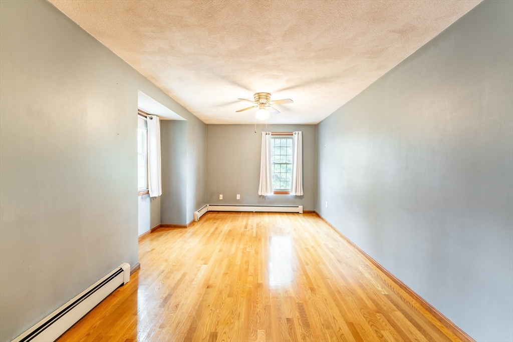 375 Winter Street Walpole, MA 02081 - Photo 28 of 40 a view of an empty room with window and wooden floor
