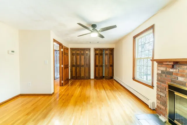 a view of a room with wooden floor and natural light