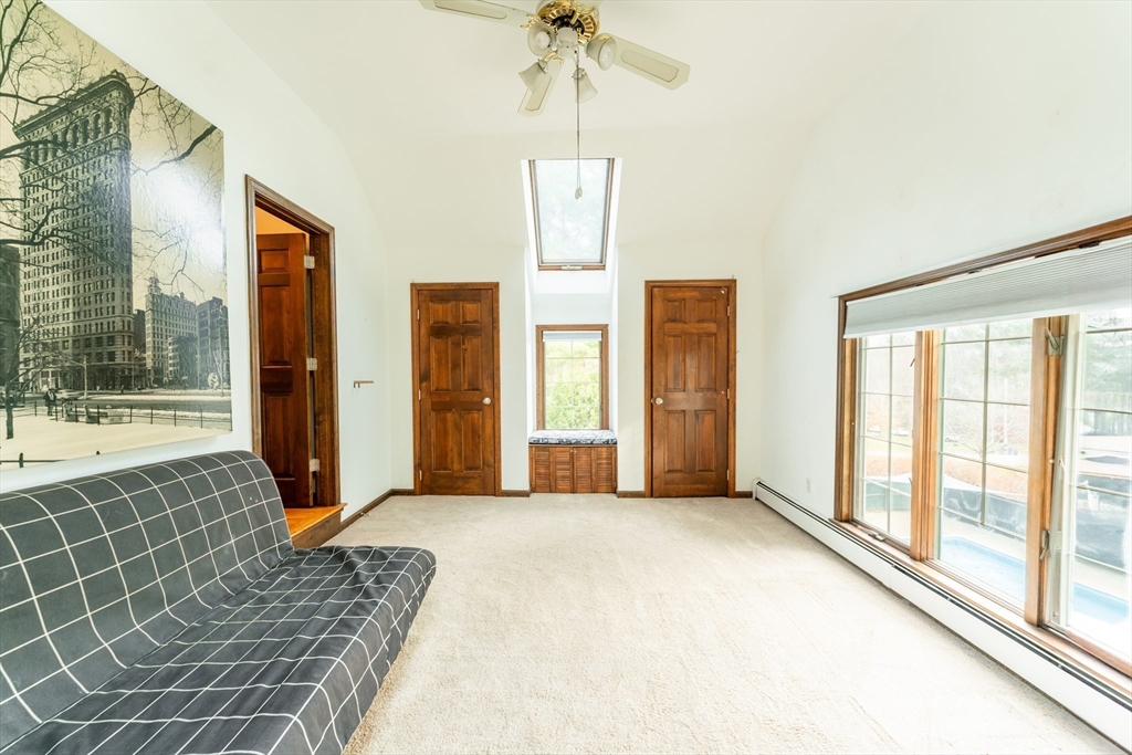 375 Winter Street Walpole, MA 02081 - Photo 35 of 40 a bedroom with a bed and a chandelier