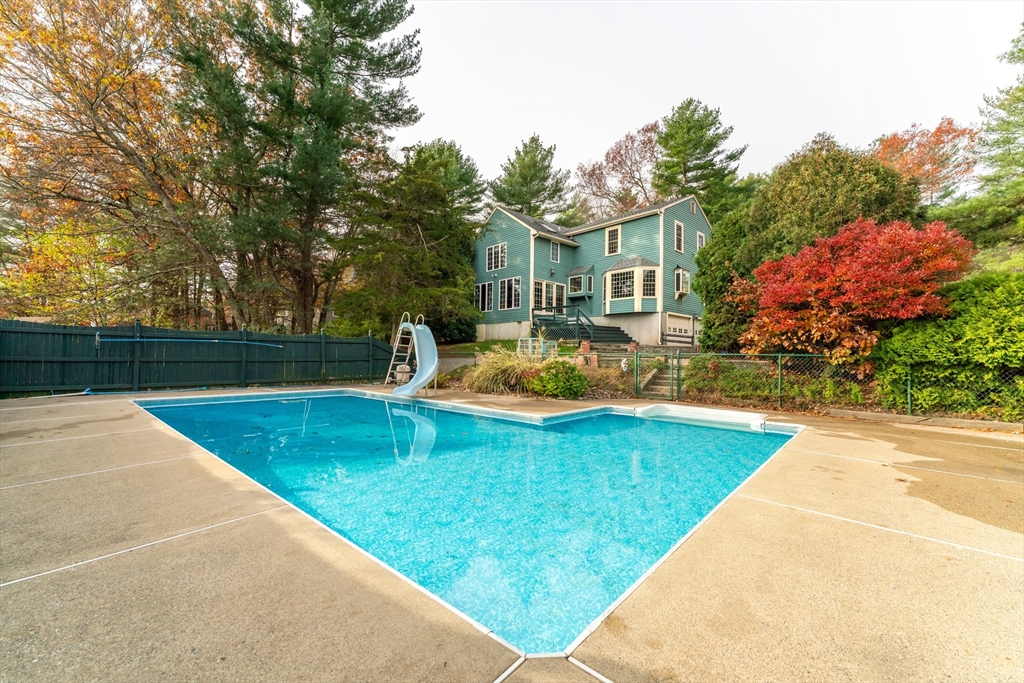 375 Winter Street Walpole, MA 02081 - Photo 40 of 40 a view of a swimming pool with a garden and trees