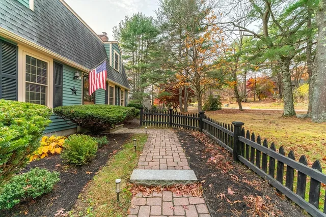 a view of a pathway with a wrought fence
