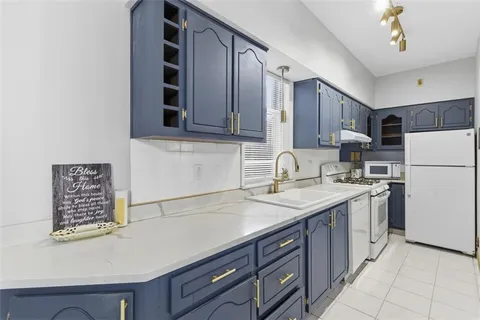 a kitchen with a sink and a refrigerator