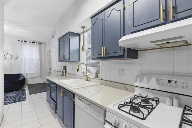 a kitchen with stainless steel appliances a sink a stove and a refrigerator