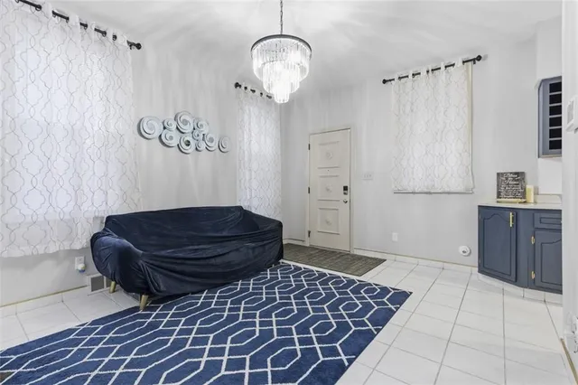 a living room with a couch and a chandelier