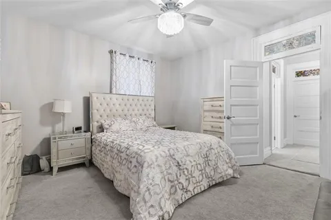 a bedroom with a bed and a chandelier