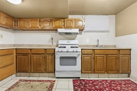 a view of a kitchen with a refrigerator and chandelier