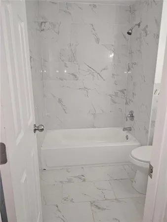 a bathroom with a bathtub and toilet