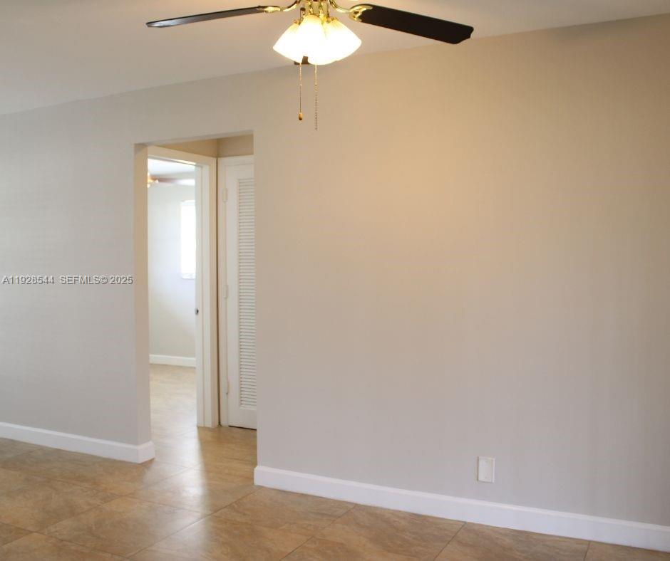 5709 Northwest 64th Way Tamarac, FL 33321 - Photo 12 of 51 a view of an empty room with wooden floor
