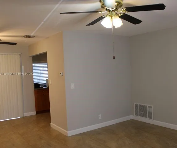 a view of an empty room with a fan