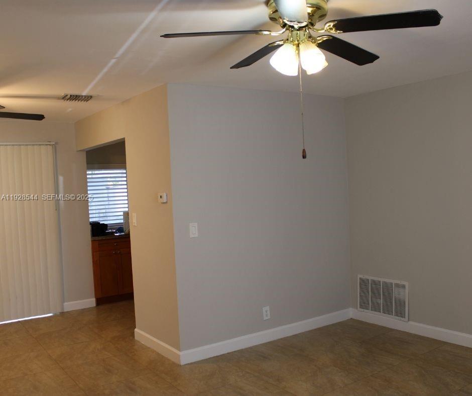 5709 Northwest 64th Way Tamarac, FL 33321 - Photo 14 of 51 a view of an empty room with a fan