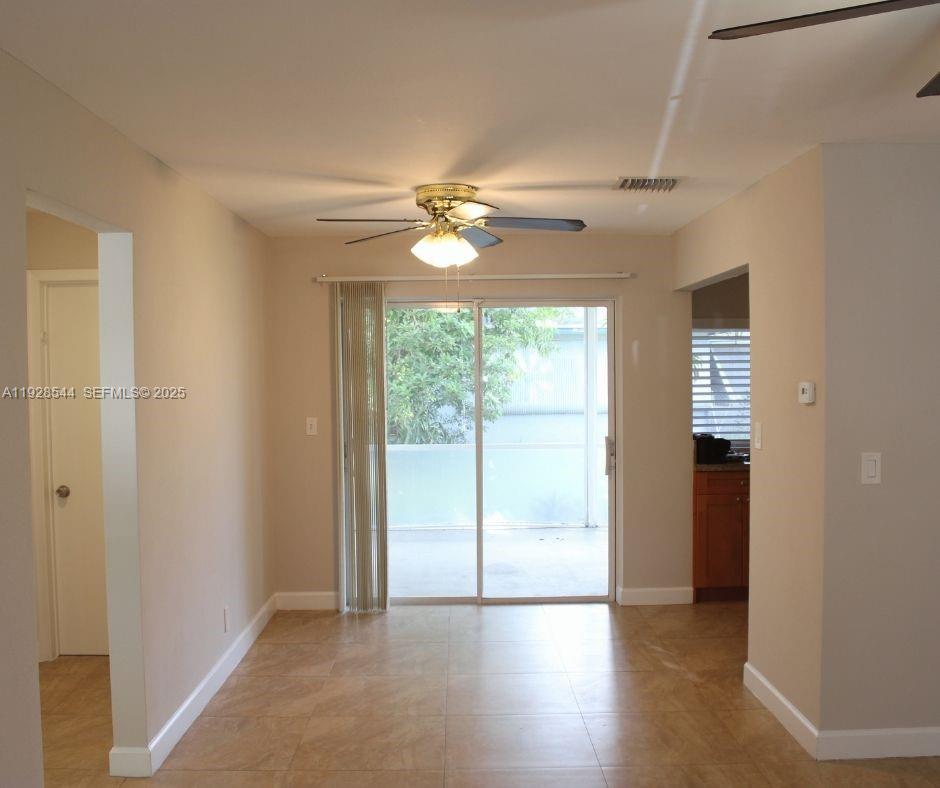 5709 Northwest 64th Way Tamarac, FL 33321 - Photo 16 of 51 wooden floor in an empty room with a window