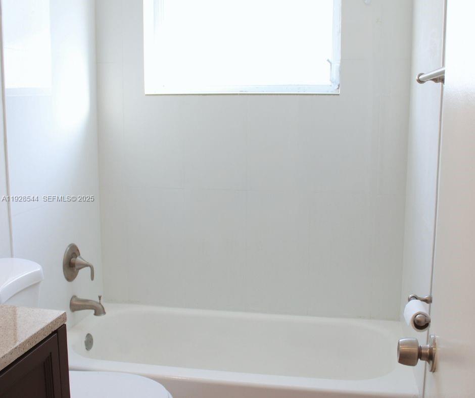 5709 Northwest 64th Way Tamarac, FL 33321 - Photo 29 of 51 a bathroom with a bathtub