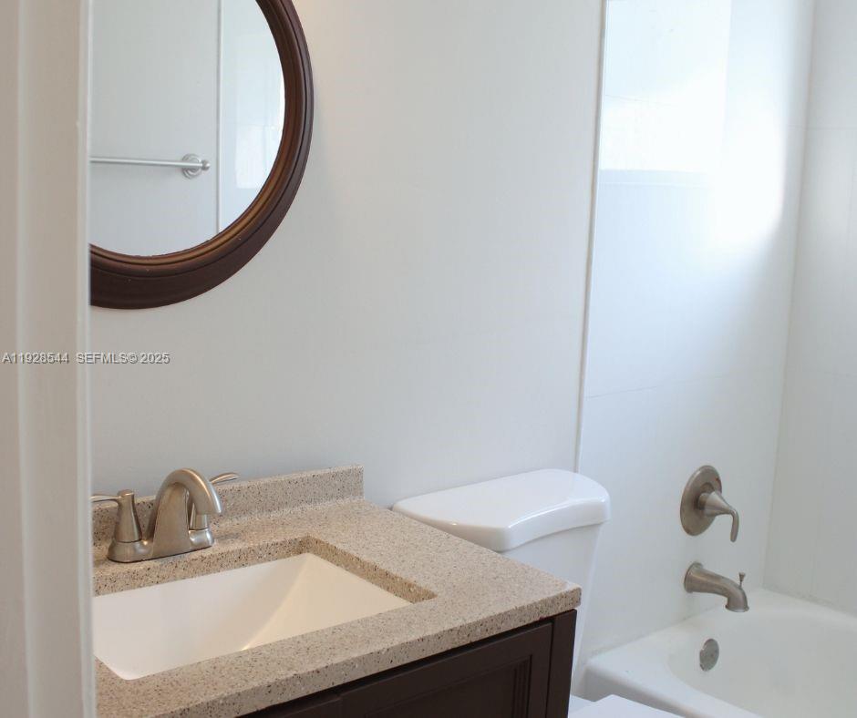 5709 Northwest 64th Way Tamarac, FL 33321 - Photo 38 of 51 a bathroom with a sink and a mirror