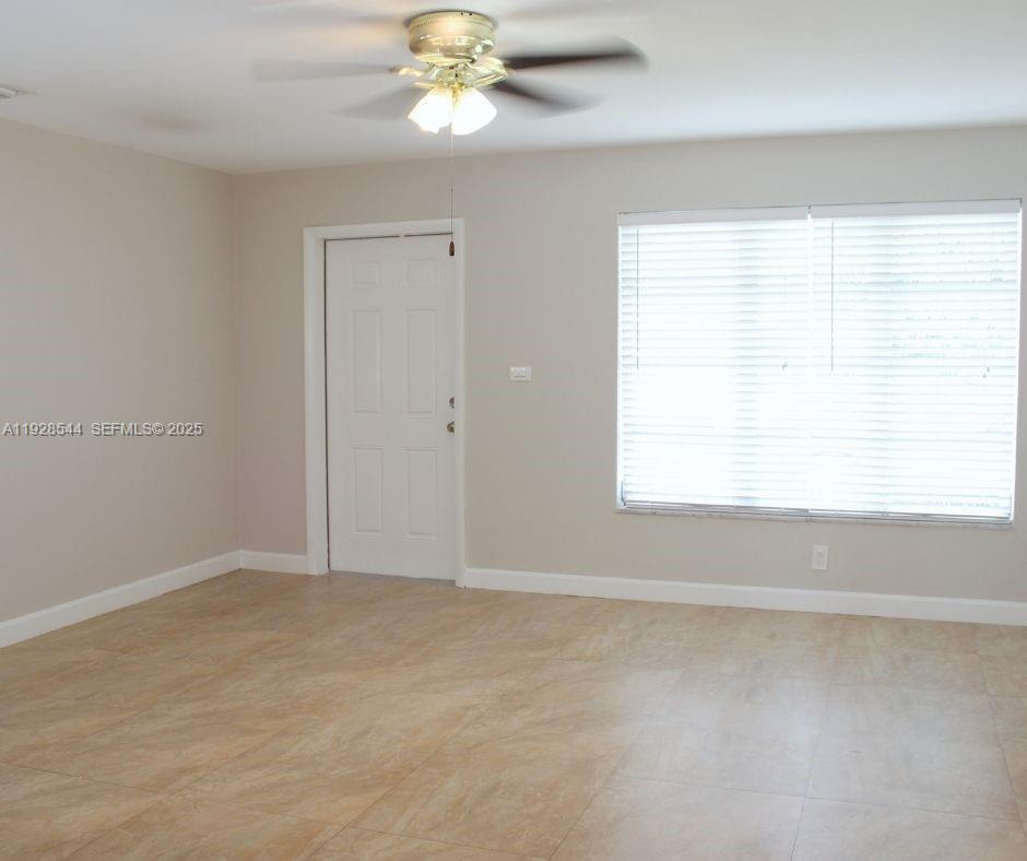 5709 Northwest 64th Way Tamarac, FL 33321 - Photo 6 of 51 a view of an empty room with a window