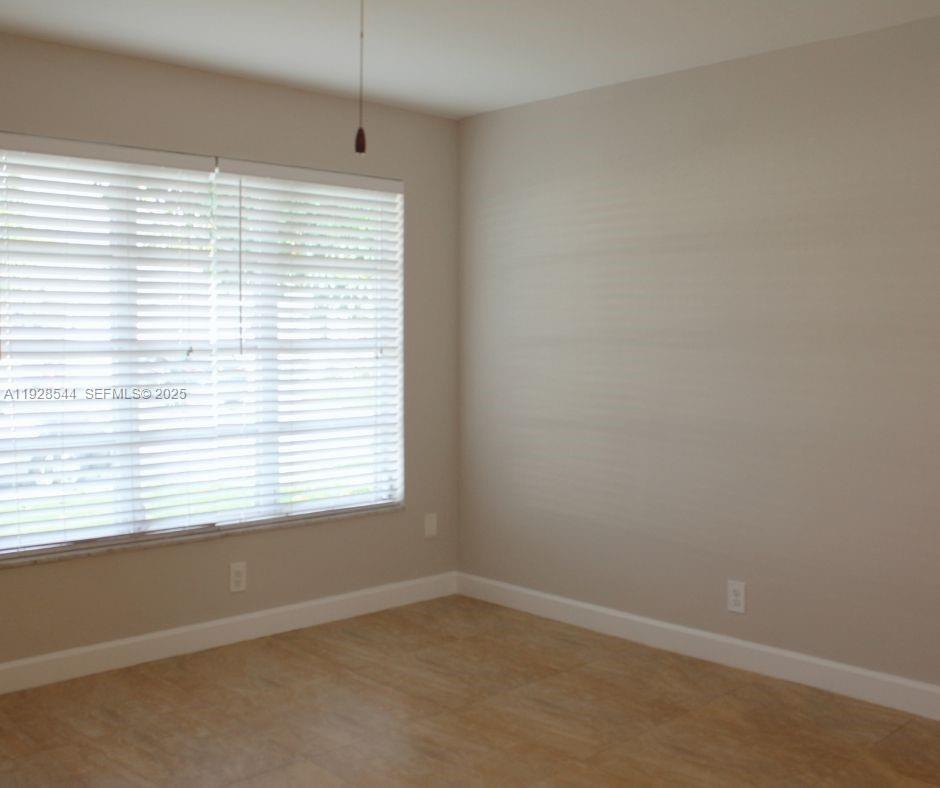 5709 Northwest 64th Way Tamarac, FL 33321 - Photo 9 of 51 an empty room with a window