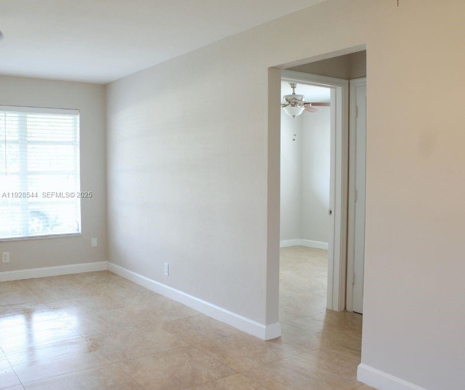 5709 Northwest 64th Way Tamarac, FL 33321 - Photo 10 of 51 an empty room with a window and a bathroom