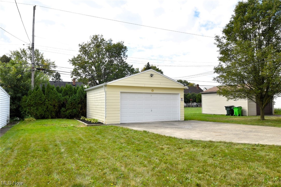 13300 Rockside Road Garfield Heights, OH 44125 - Photo 30 of 32 Garage featuring a lawn