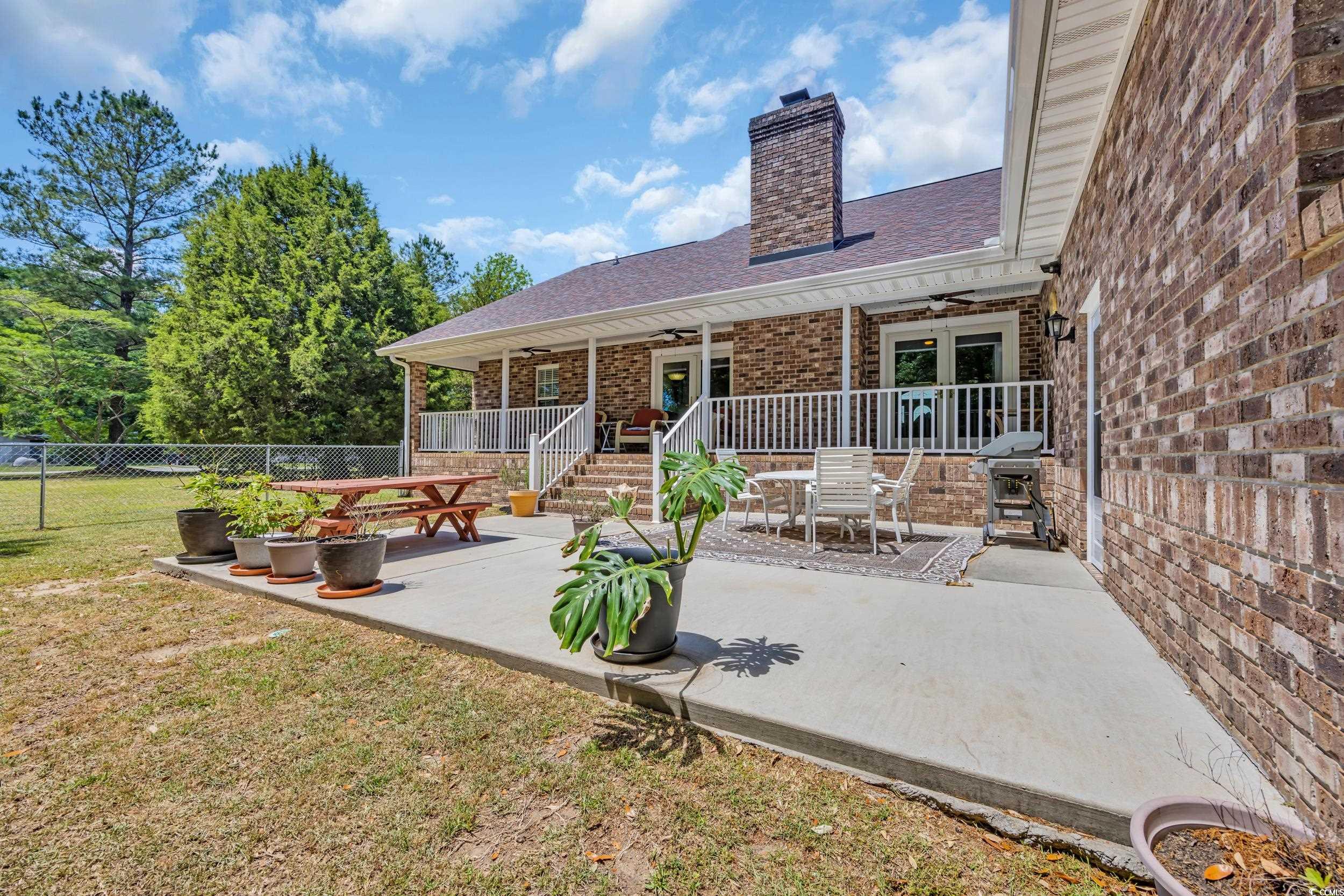 1014 Academy Drive Conway, SC 29526 - Photo 24 of 40 Back of house with fence, ceiling fan, a chimney,