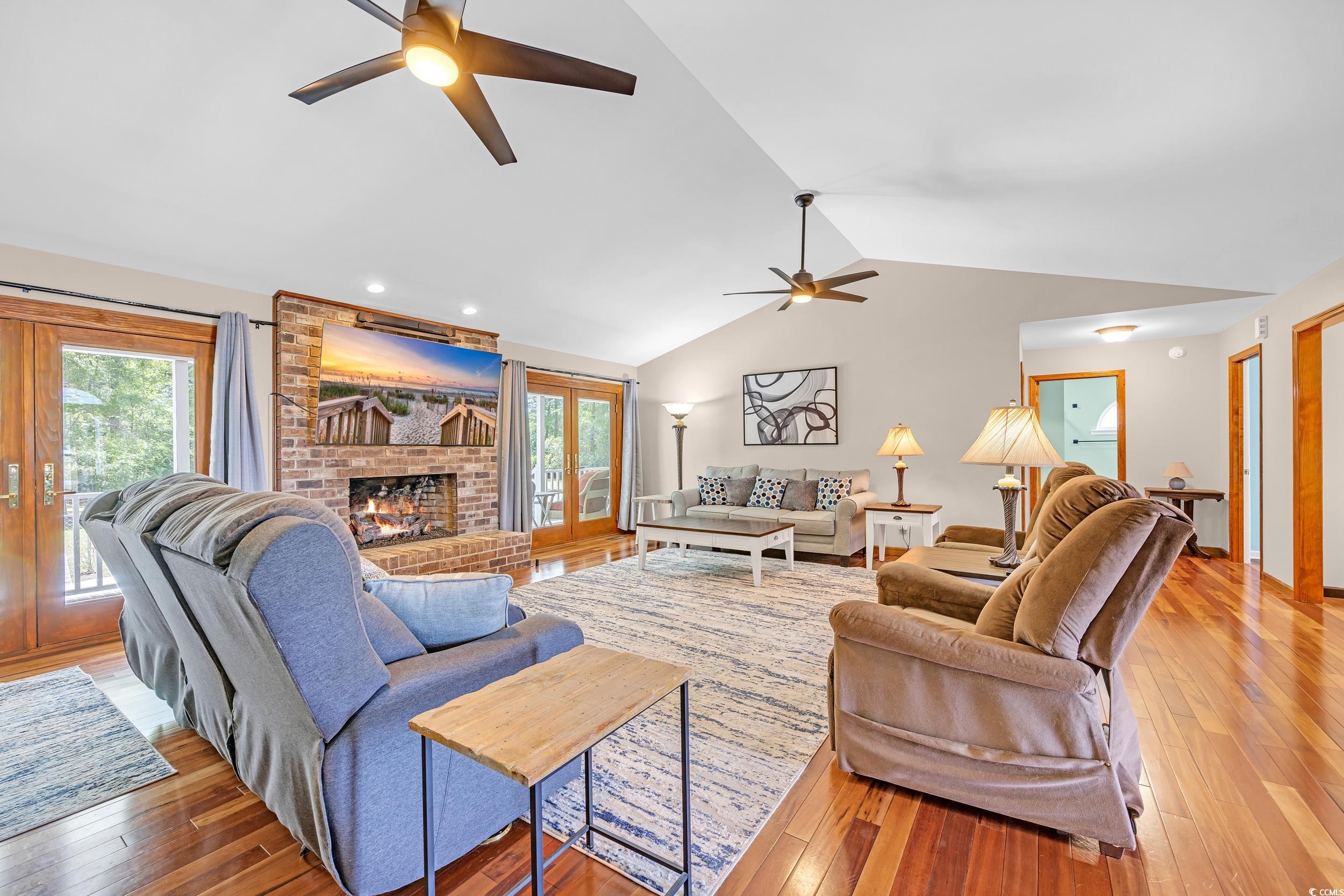1014 Academy Drive Conway, SC 29526 - Photo 4 of 40 Living area featuring a brick fireplace, light woo