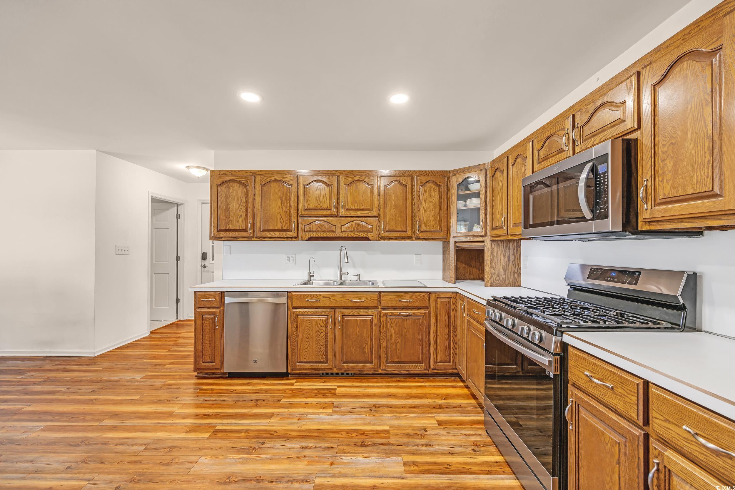 1014 Academy Drive Conway, SC 29526 - Photo 8 of 40 Kitchen with brown cabinetry, a sink, light counte