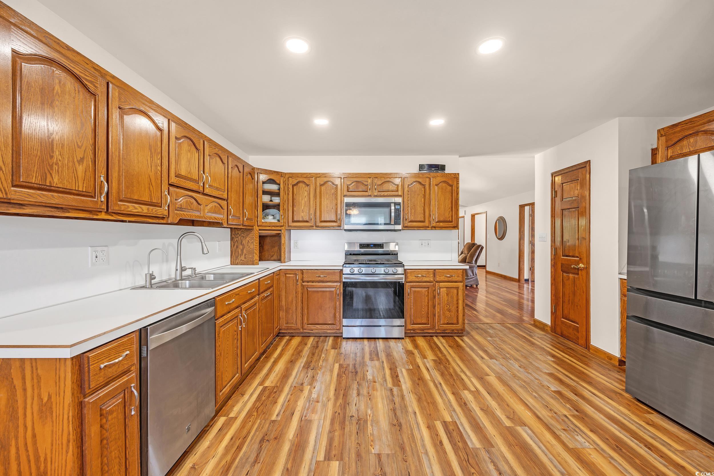 1014 Academy Drive Conway, SC 29526 - Photo 9 of 40 Kitchen featuring brown cabinetry, a sink, light c