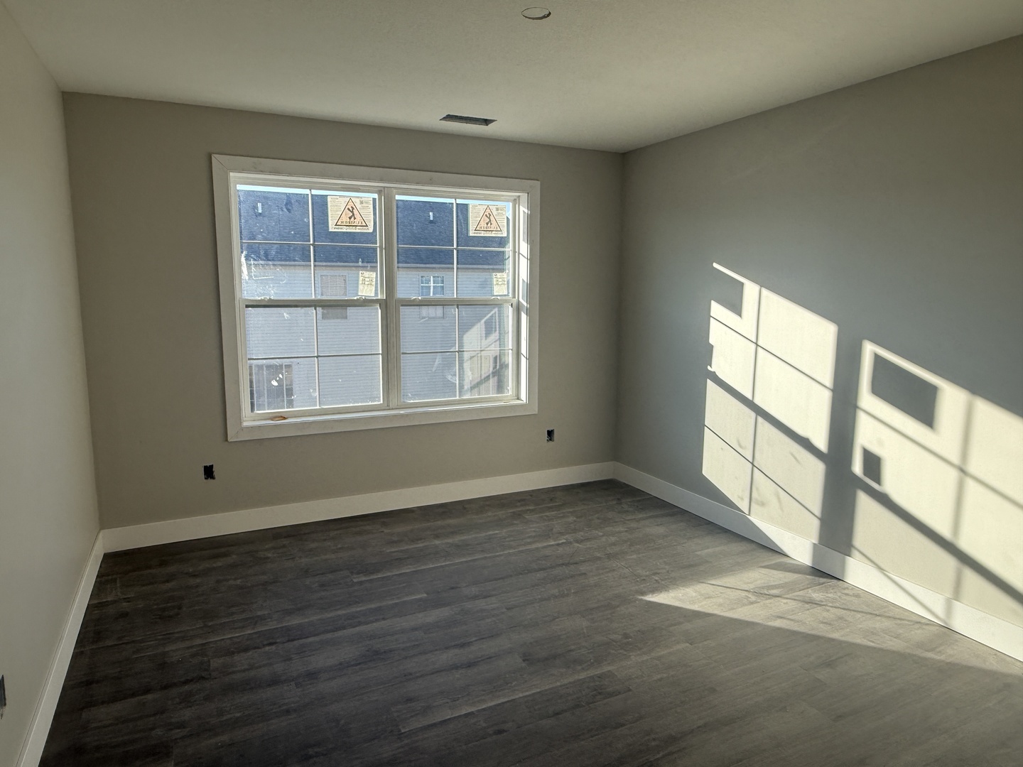 1409 Sand Dollar Drive Champaign, IL 61822 - Photo 9 of 12 an empty room with wooden floor and windows