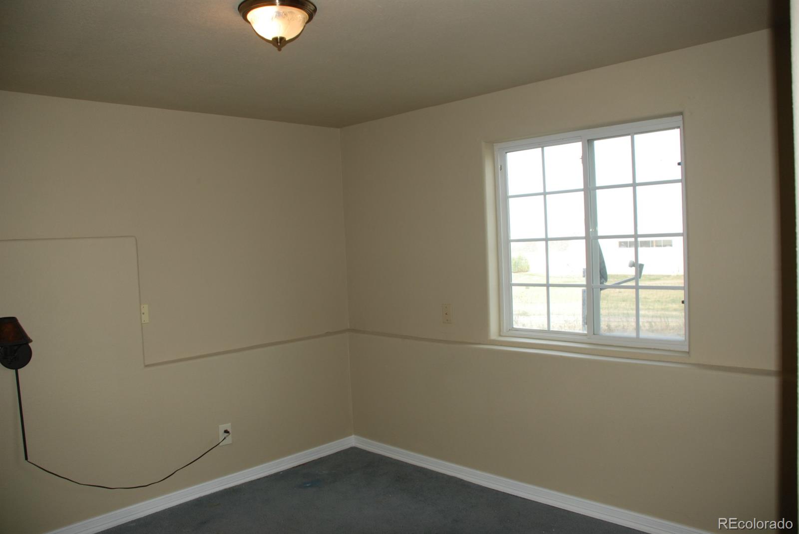 8979 Lariat Loop Elizabeth, CO 80107 - Photo 15 of 17 an empty room with a window