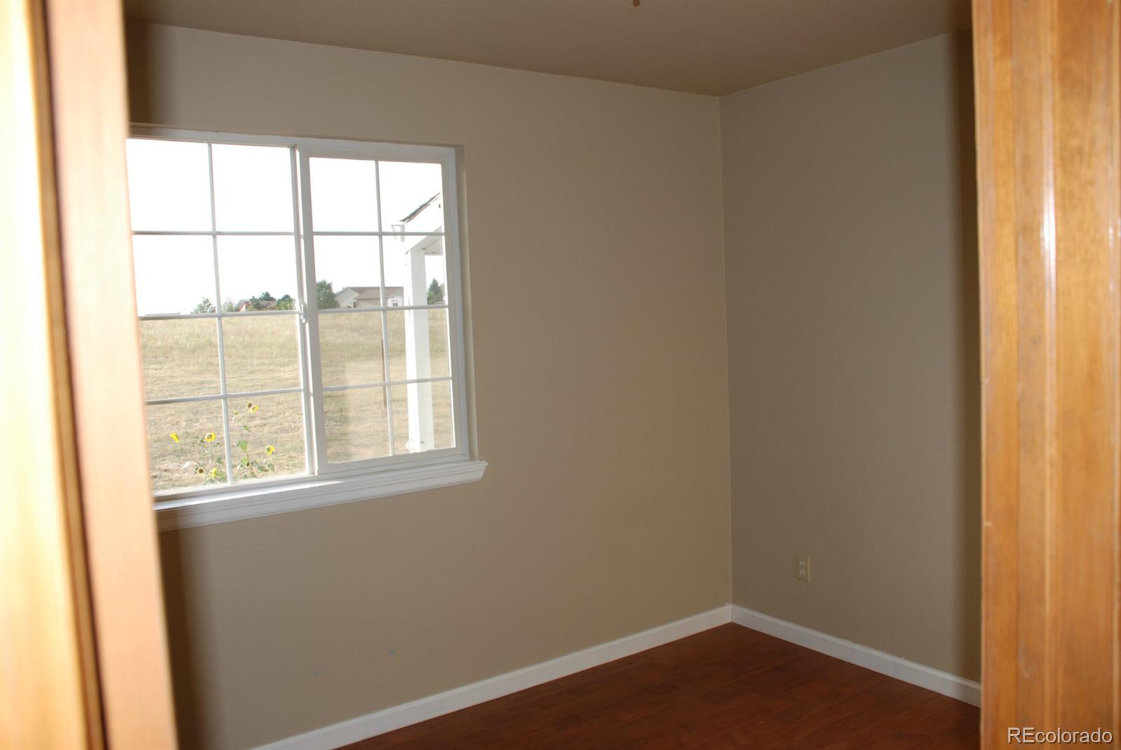 8979 Lariat Loop Elizabeth, CO 80107 - Photo 4 of 17 an empty room with a window