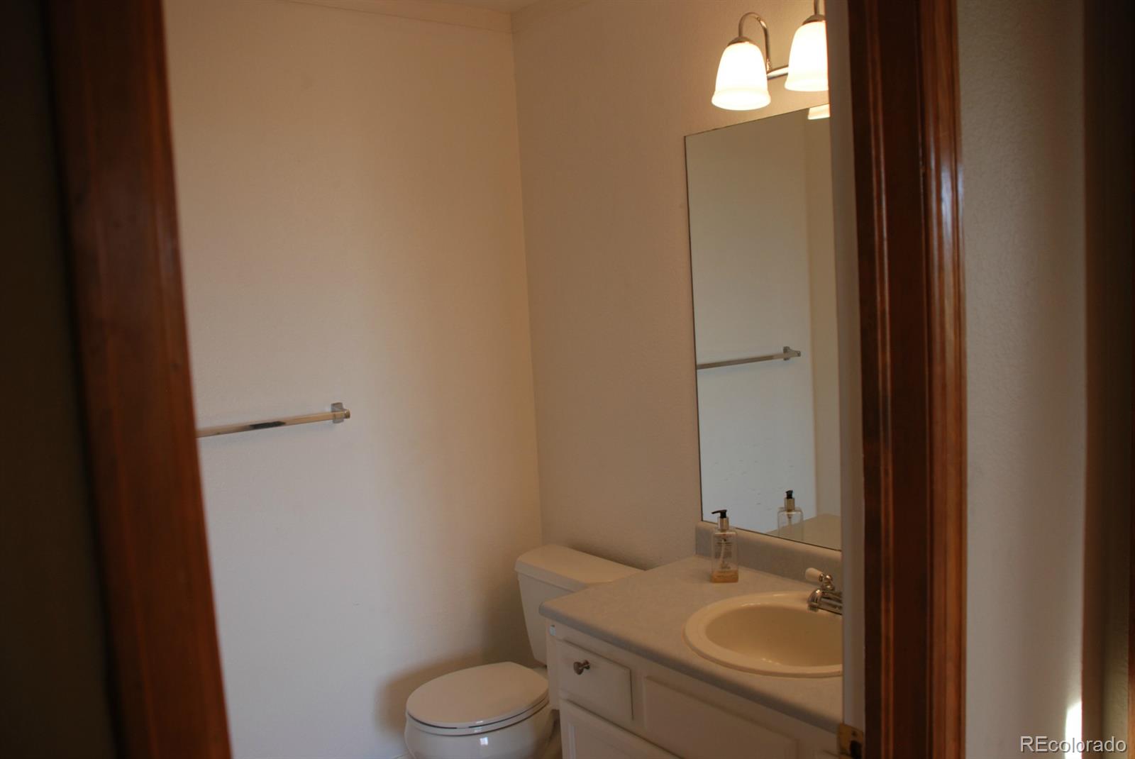 8979 Lariat Loop Elizabeth, CO 80107 - Photo 7 of 17 a bathroom with a sink toilet and vanity