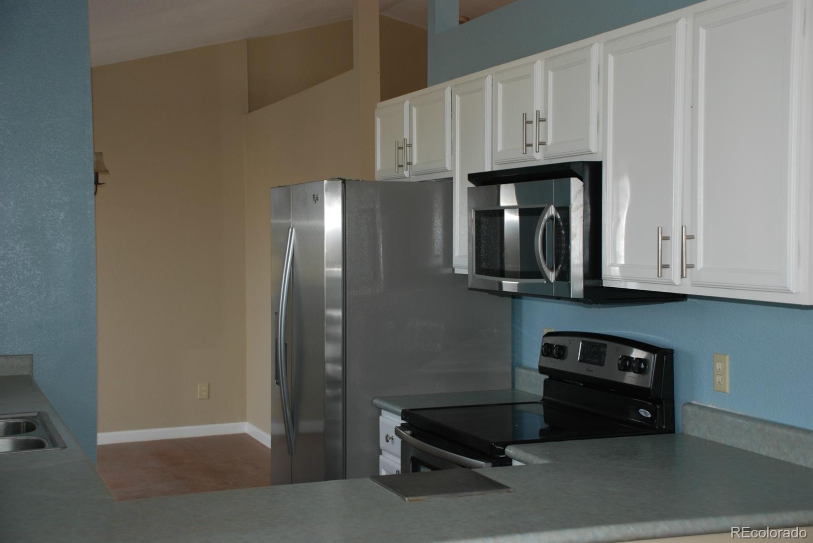 8979 Lariat Loop Elizabeth, CO 80107 - Photo 9 of 17 a kitchen with stainless steel appliances granite countertop a refrigerator and a stove