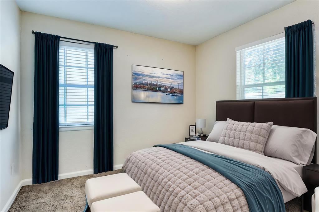 4312 Ridgedale Drive Mesquite, TX 75150 - Photo 12 of 23 a bedroom with a large bed and a couch