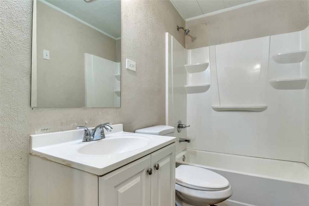 4312 Ridgedale Drive Mesquite, TX 75150 - Photo 14 of 23 a bathroom with a sink a toilet and shower