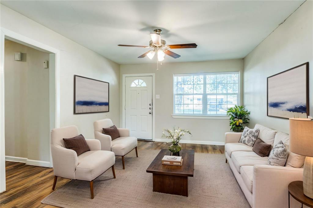 4312 Ridgedale Drive Mesquite, TX 75150 - Photo 4 of 23 a living room with furniture a chandelier and a window