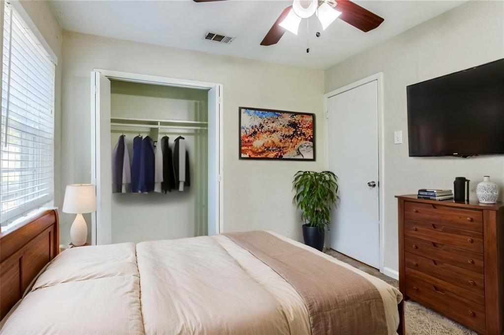 4312 Ridgedale Drive Mesquite, TX 75150 - Photo 9 of 23 a bedroom with a bed and a flat screen tv