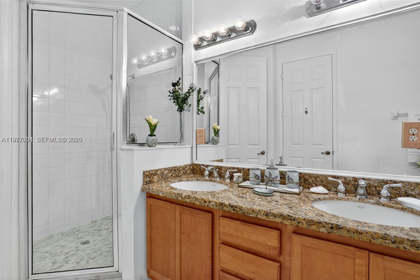 728 Southeast 2nd Street Pompano Beach, FL 33060 - Photo 13 of 22 a bathroom with a granite countertop sink and a mirror