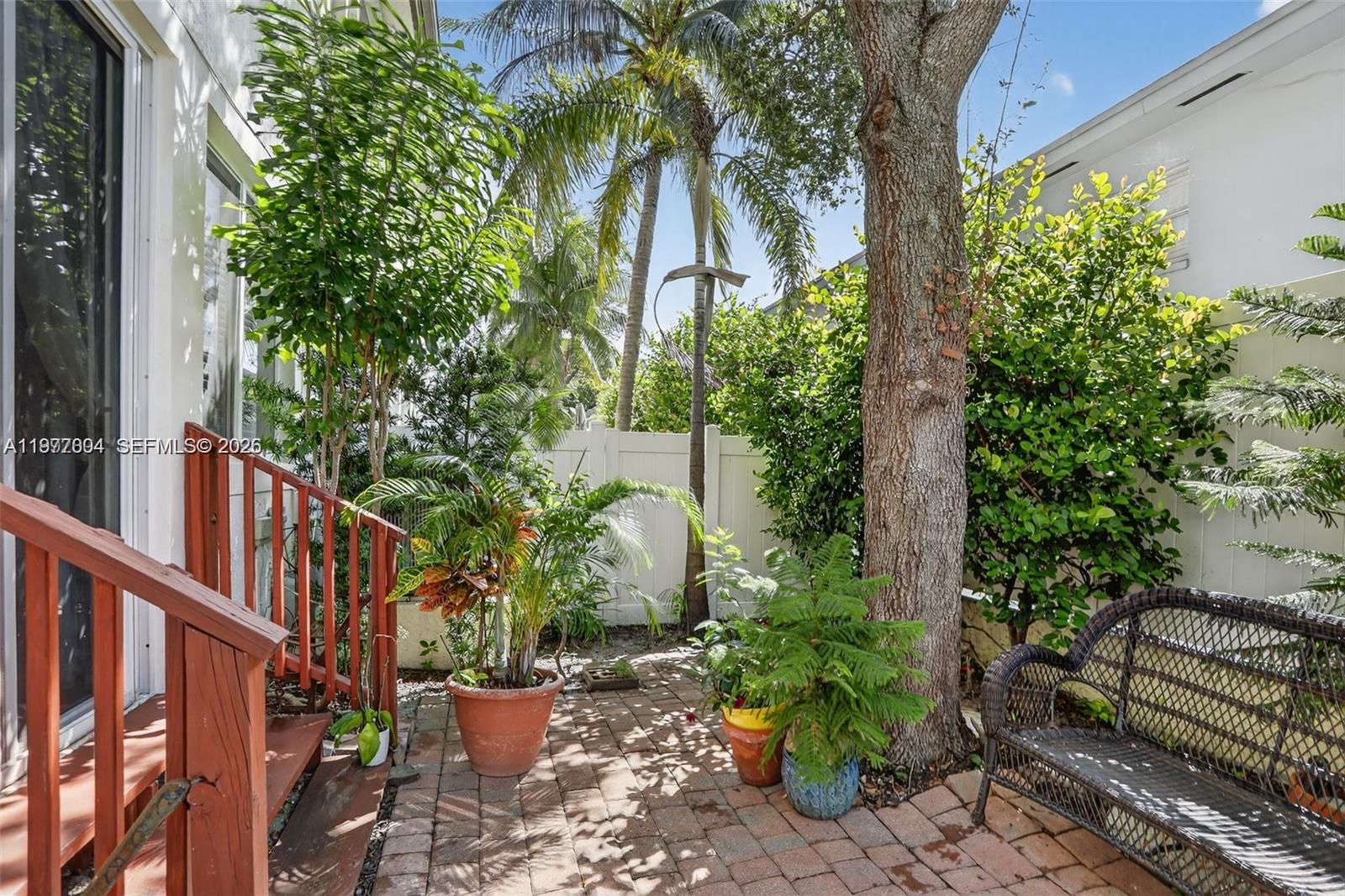 728 Southeast 2nd Street Pompano Beach, FL 33060 - Photo 20 of 22 a view of a bench in a backyard