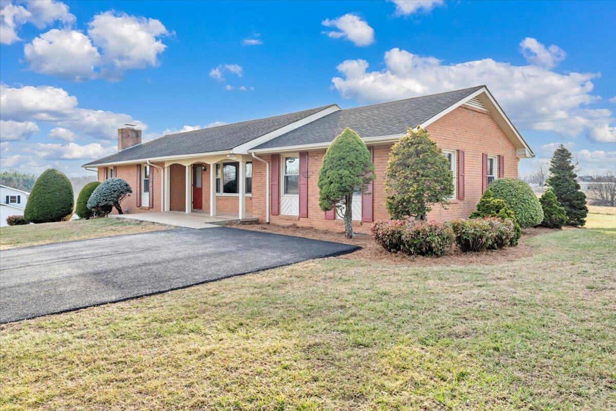 5985 Collier Street Dublin, VA 24084 - Photo 16 of 53 a view of a house with a yard and potted plants