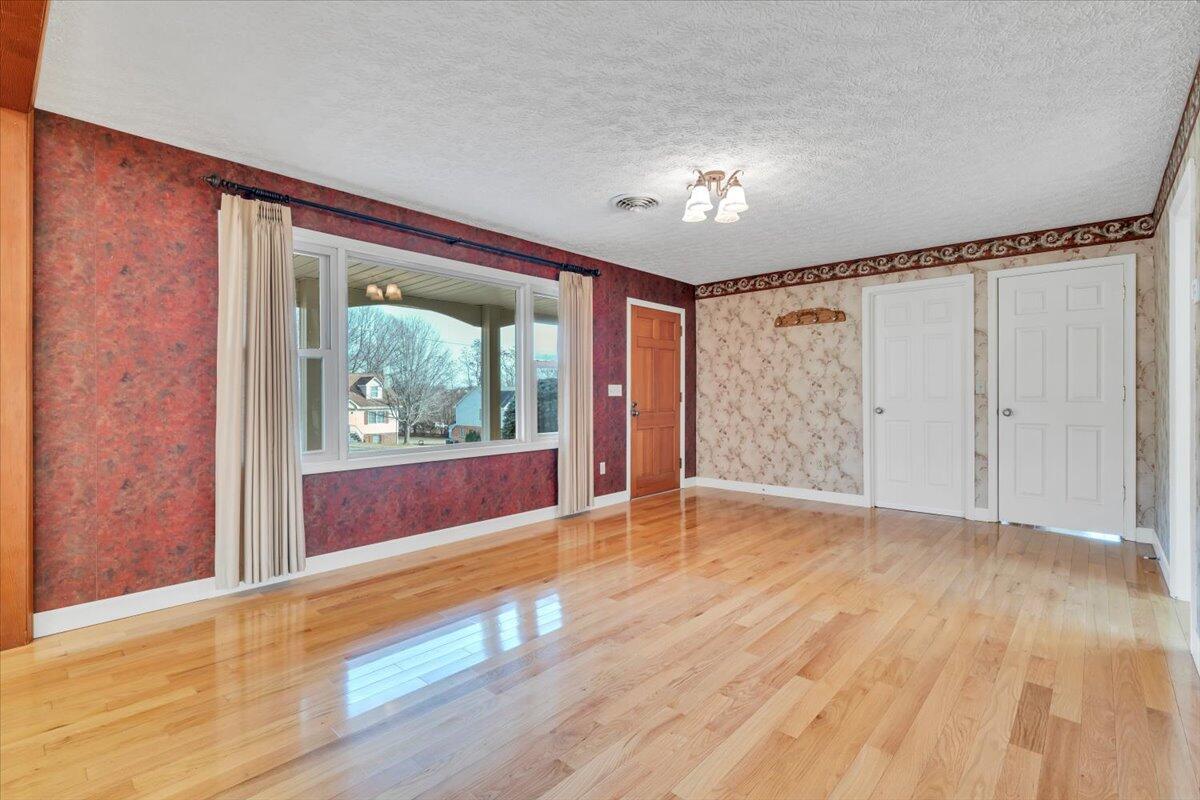 5985 Collier Street Dublin, VA 24084 - Photo 19 of 53 a view of an empty room with a window and wooden floor