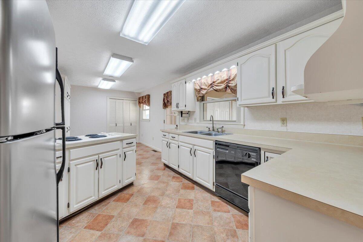 5985 Collier Street Dublin, VA 24084 - Photo 24 of 53 a kitchen with granite countertop a sink stainless steel appliances and cabinets