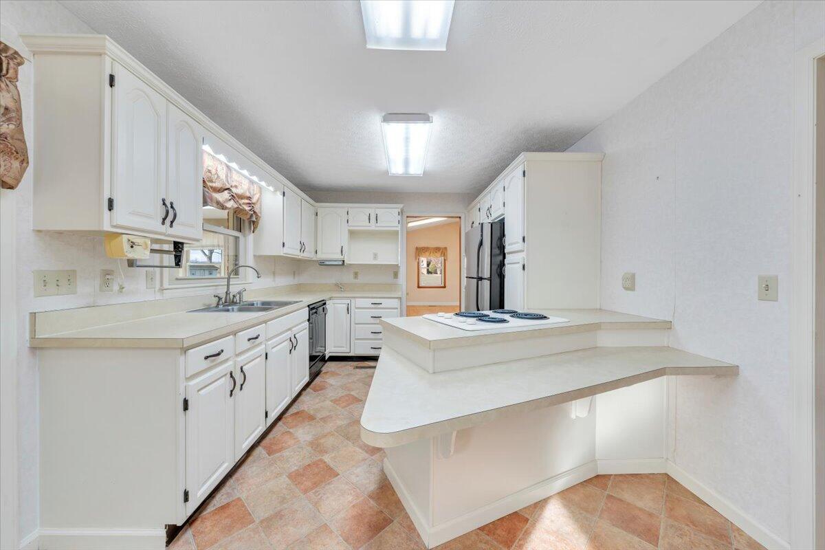 5985 Collier Street Dublin, VA 24084 - Photo 27 of 53 a kitchen with stainless steel appliances granite countertop a sink and cabinets