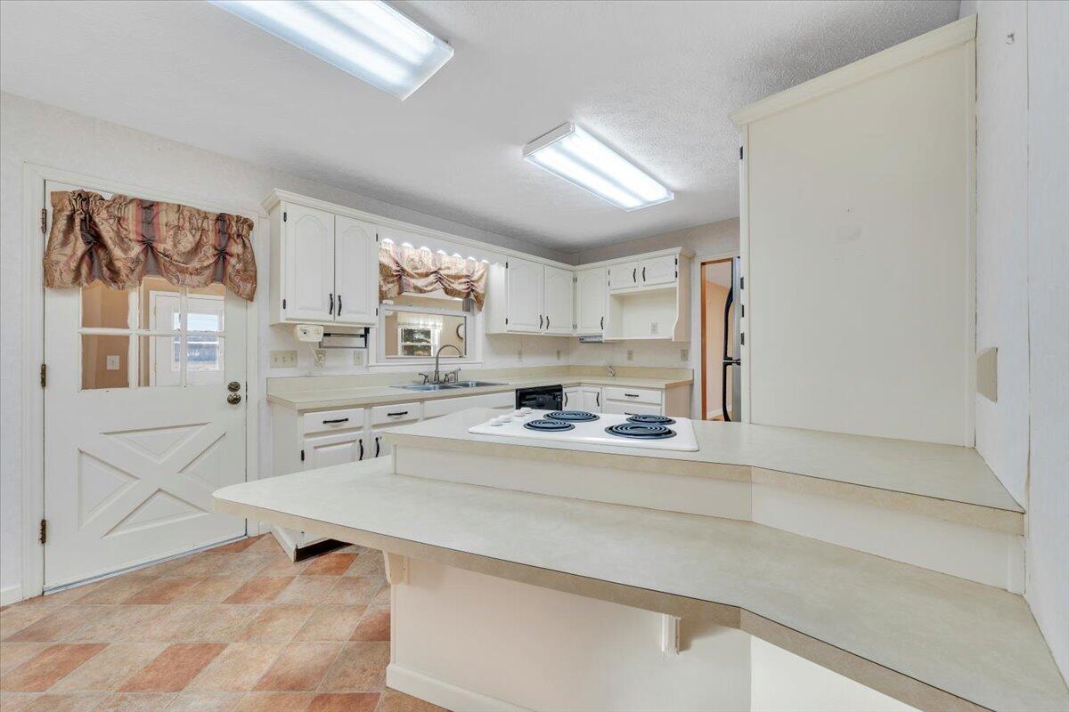 5985 Collier Street Dublin, VA 24084 - Photo 28 of 53 a kitchen with stainless steel appliances a sink stove and cabinets