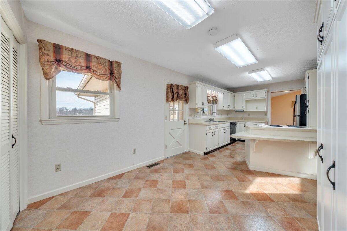 5985 Collier Street Dublin, VA 24084 - Photo 30 of 53 a view of a kitchen with a sink cabinets and a window