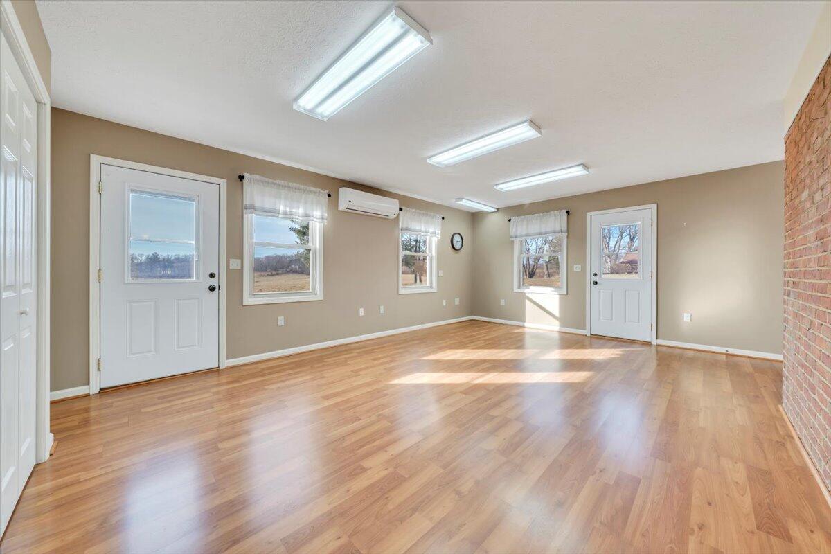 5985 Collier Street Dublin, VA 24084 - Photo 31 of 53 a view of an empty room with wooden floor and a window
