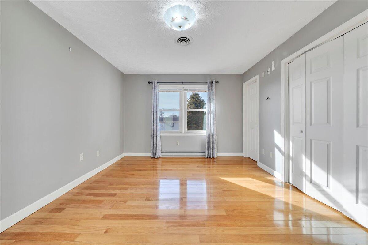5985 Collier Street Dublin, VA 24084 - Photo 36 of 53 a view of an empty room with wooden floor and a window