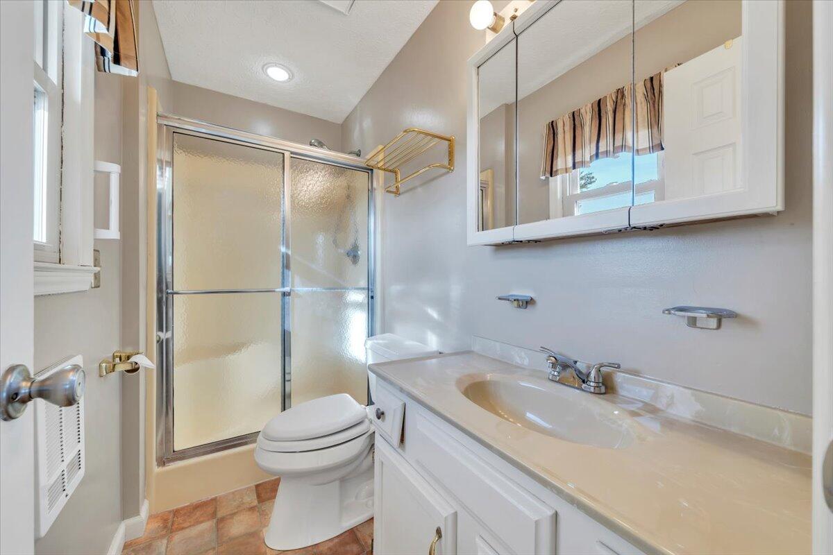 5985 Collier Street Dublin, VA 24084 - Photo 37 of 53 a bathroom with a granite countertop sink toilet and shower