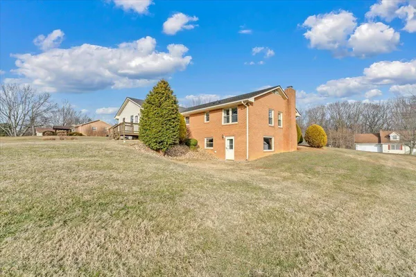 a view of a yard with a house in the background