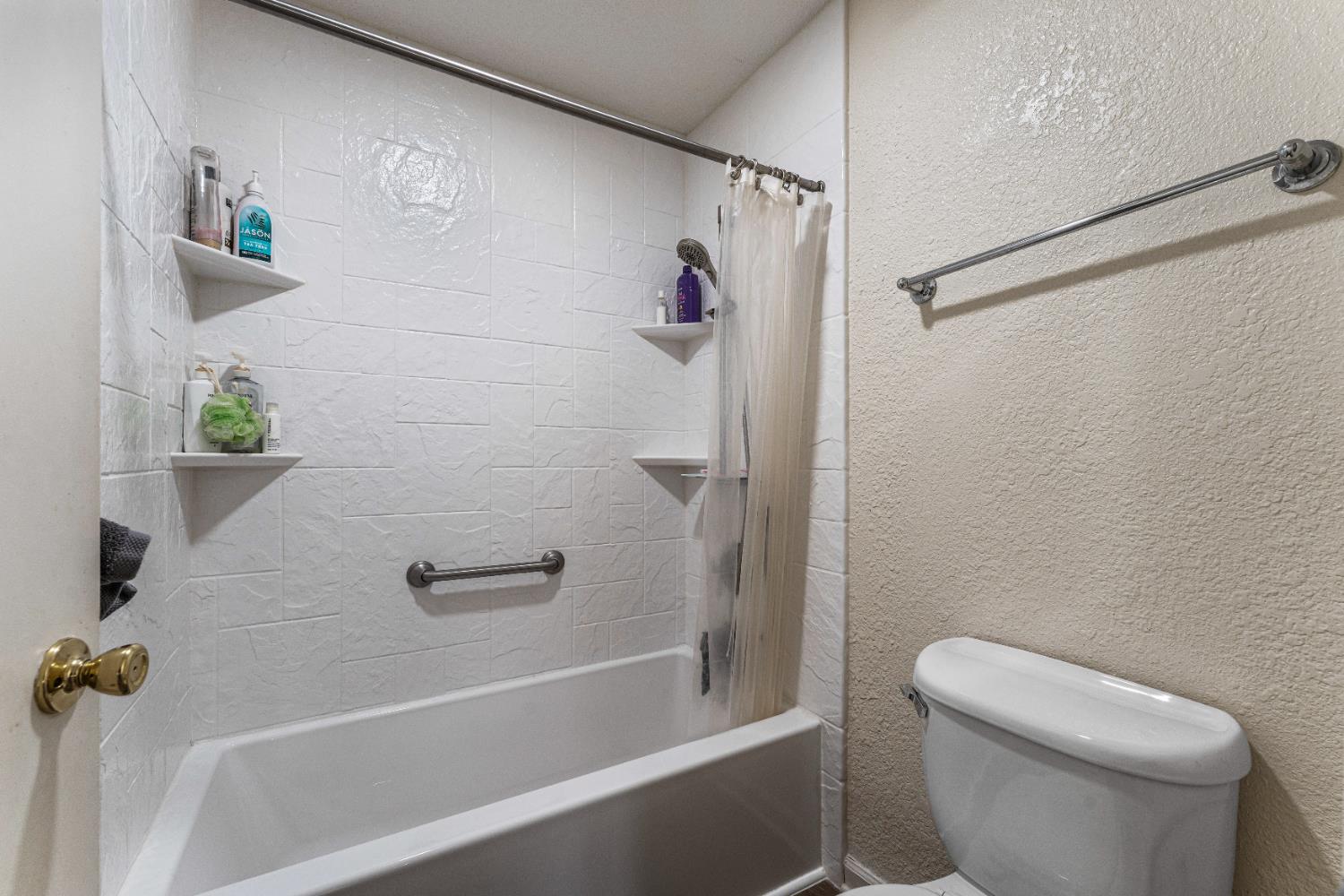 1019 Dornajo Way, Unit 123 Sacramento, CA 95825 - Photo 16 of 23 a bathroom with a shower and a toilet